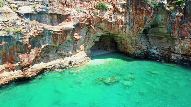 Blue Cave Finike Antalya aerial view showcasing a famous Mediterranean sea cave destination. Dramatic drone shot capturing vibrant turquoise water and rocky coast.