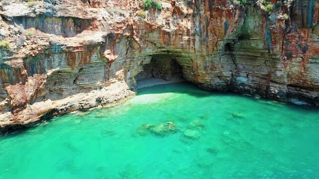 Blue Cave Finike Antalya aerial view showcasing a famous Mediterranean sea cave destination. Dramatic drone shot capturing vibrant turquoise water and rocky coast.