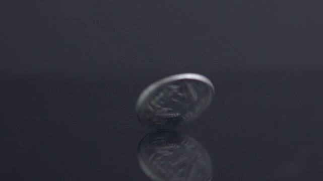 25 cent coin quarter bouncing spinning crypto economy dark money background cash