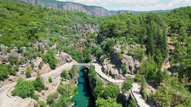 Aerial view of Koprulu Canyon in Manavgat, Antalya, showcasing the dramatic river gorge and lush green forest landscape. Majestic drone shot over Turkey's famous national park.
