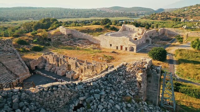 Patara ancient theater and parliament building aerial view highlighting iconic Lycian archaeological ruins in Antalya, Turkey. Dramatic drone shot over history.