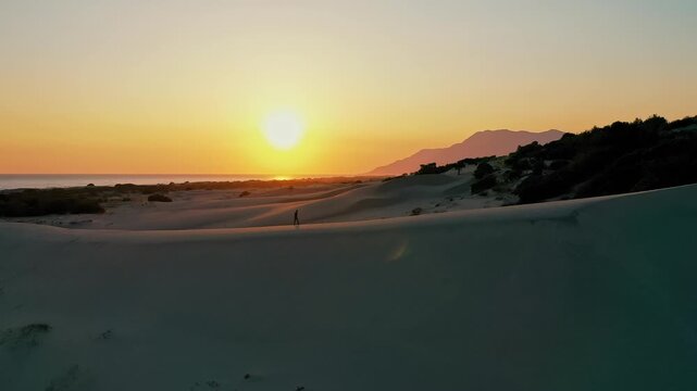 Patara sand dunes sunset aerial view capturing the dramatic golden hour light over the vast desert-like landscape in Antalya, Turkey. Majestic drone shot of coastal dunes.