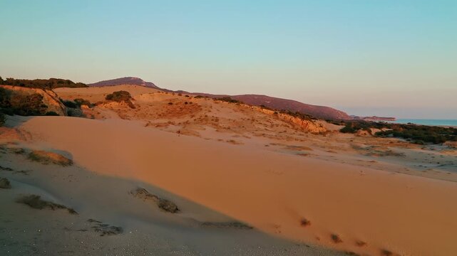 Patara sand dunes sunset aerial view capturing the dramatic golden hour light over the vast desert-like landscape in Antalya, Turkey. Majestic drone shot of coastal dunes.