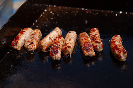 Cooking Breakfast Sausages 2. Sausages cooked for breakfast on an outdoor grill while camping.