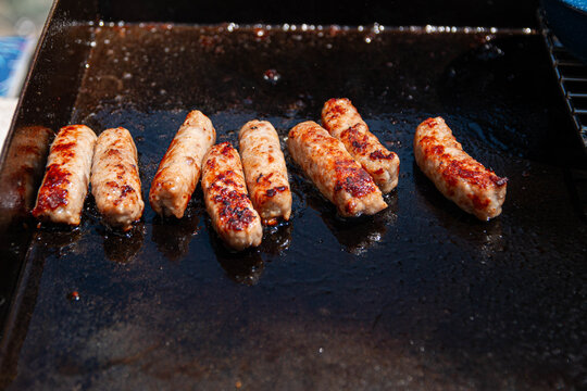 Cooking Breakfast Sausages 1. Sausages cooked for breakfast on an outdoor grill while camping.