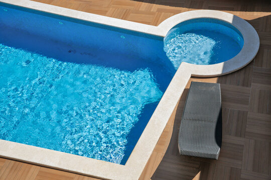 Modern swimming pool edge with sun loungers.