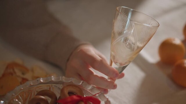 Graceful domestic scene. Soft moments with glassware captured. Subtle domestic ambiance illuminated softly. Elegant everyday routine highlighted by gentle lighting and delicate movements