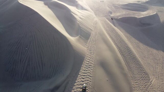 Dune buggy safari driving on sand dunes in huacachina, peru