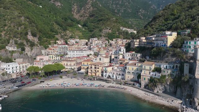 Aerial view of the colorful houses and beach of the coastal village of Cetara, nestled against the green cliffs of the Amalfi Coast, Cetara, Amalfi Coast, Italy.