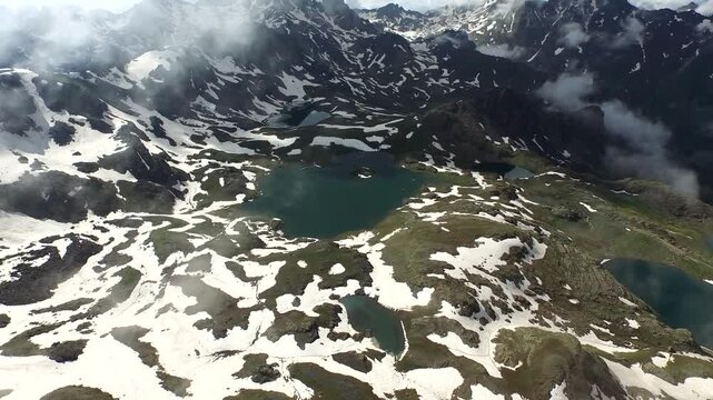 Aerial view of Yedigoller Ispir Erzurum lake shows Kackar Mountains and spring snow.