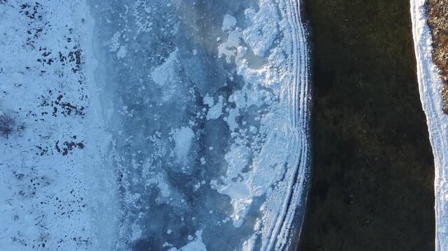 Aerial drone footage shows a frozen river amid Russia's severe winter conditions.