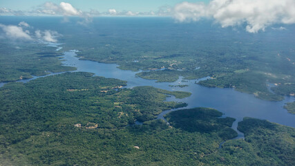 Naklejka premium Aerial view over wide Negro river cutting through Amazon rainforest. Amazonas, Brazil
