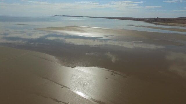 Kazakhstan Aral Lake shoreline stretches across sand, shallow water, and dry desert coast.