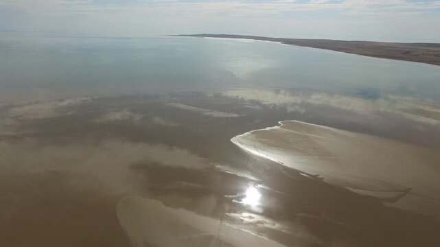 Kazakhstan Aral Lake shoreline stretches across sand, shallow water, and dry desert coast.