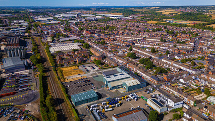 Fototapeta premium High altitude aerial overview of town cityscape and industrial yards