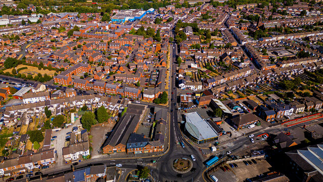 Dense residential neighborhood and roundabout traffic aerial drone shot