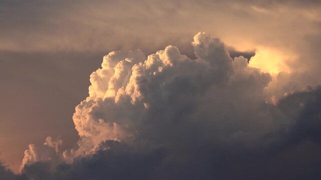 Time lapse shows pink orange storm clouds erupting in glowing sunset sky after rainfall.