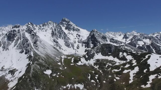 Snowy Kackar Mountains Rize Turkey surround tarn lake, icy peaks, rugged cirque basin.