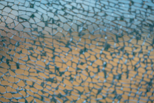 Broken tempered glass window in detail.