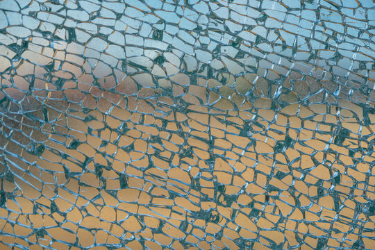 Broken tempered glass window in detail.
