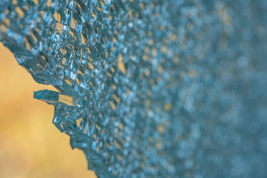 Broken tempered glass window in detail.