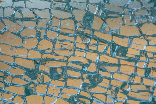 Broken tempered glass window in detail.