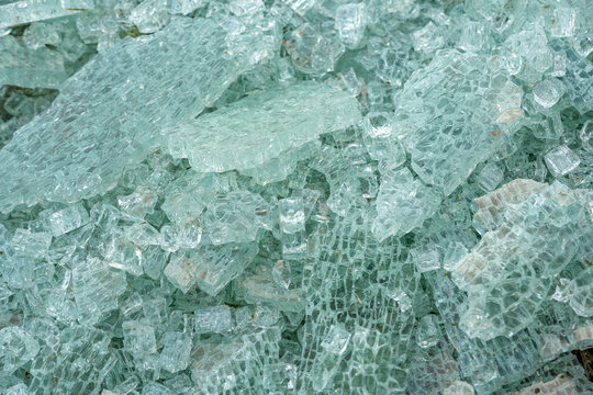 Tempered glass shattered into pieces and piled up on the floor.