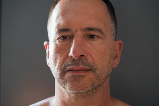Close-up of an introspective-looking white European man.