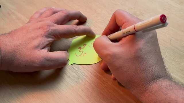 Hand writing traditional Arabic calligraphy with reed pen on paper