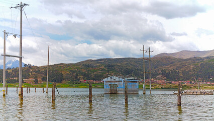 Fototapeta premium Estación eléctrica rural abandonada e inundada en una laguna en el atardecer
