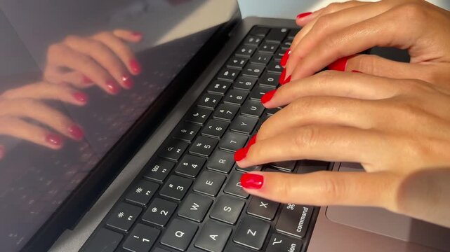 4K macro close-up video of a woman's hands typing on a computer keyboard, representing online business, digital communication and the fast pace of modern work