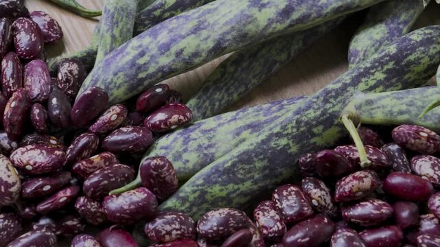 Pinto beans and green beans on wooden table panning handheld camera, 4K