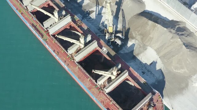 Aerial view of a bulk-carrier ship downloading in the Mediterranean Spanish port of Alicante.