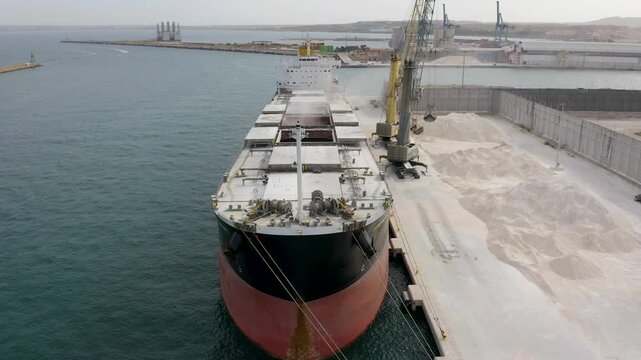 Aerial view of a bulk-carrier ship downloading in the Mediterranean Spanish port of Alicante.