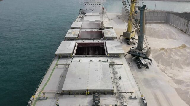 Aerial view of a bulk-carrier ship downloading in the Mediterranean Spanish port of Alicante.