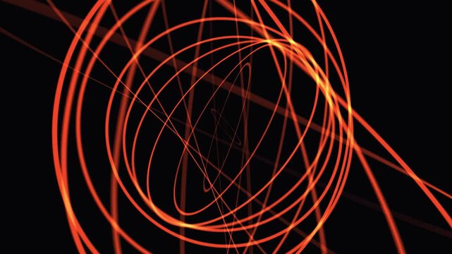 Abstract orange light trails swirling in darkness during a long exposure showing orbital paths