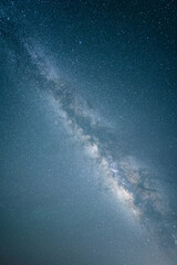 A deep-sky astrophotograph showing the Milky Way's luminous band and scattered stars across a dark night sky. © tai