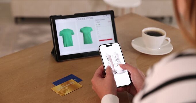 Online store. Woman using tablet and smartphone at wooden table indoors, closeup