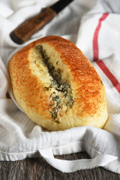 Artisan Bread Still Life. A fresh baked loaf of Garlic and Basil flavored bread on a towel.