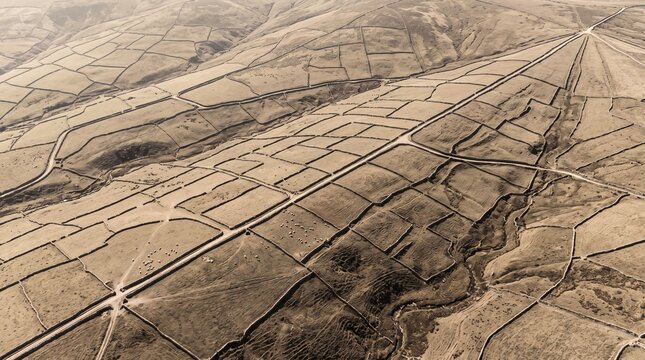 Sepia aerial view of historic dry stone walls enclosing rural fields in the countryside