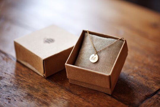 Gold necklace in cardboard box