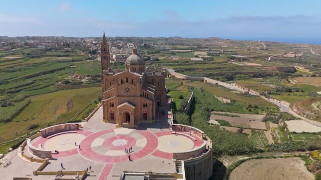 Ta' Pinu Sanctuary Basilica in Għarb, Gozo, historic Roman Catholic church and pilgrimage landmark in the Maltese countryside, with surrounding landscape captured by drone.
