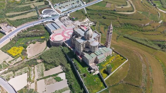 Ta' Pinu Basilica in Għarb, Gozo, Malta, surrounded by rural fields and Mediterranean countryside, Roman Catholic landmark and pilgrimage site captured by drone.