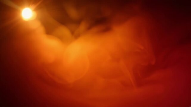 Abstract glowing orange light flare with soft bokeh and hazy atmosphere