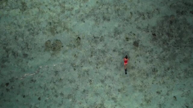 Mindful immersion and somatic wellness. Couple experiences a profound sensory connection to natural rhythm of sea, deep relaxation and restorative travel in Los Roques Archipelago