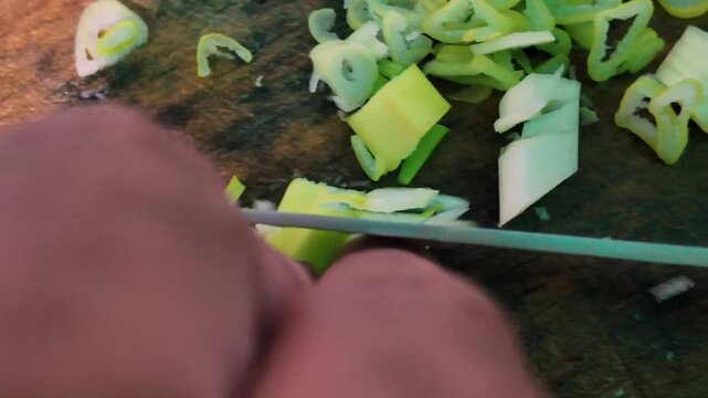 close-up culinary perspective capturing the precise knife work and preparation of fresh ingredients in a home kitchen.