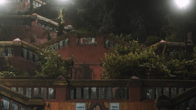 Camera zooms toward the illuminated, overgrown Heritage Steps in Panaji