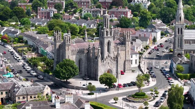 Epic aerial of Monkstown Church of Ireland on sunny day, D&uacute;n Laoghaire, Ireland