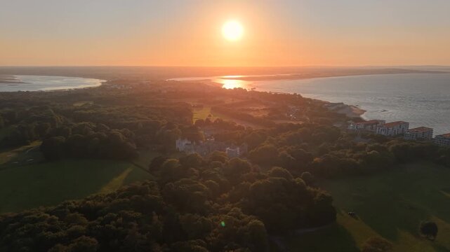 Colorful golden sunset over Howth Peninsula and Dublin Bay scenic aerial view