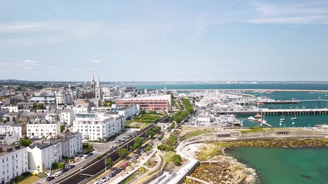 Drone flyover of D&uacute;n Laoghaire waterfront buildings and scenic seaside promenade, Ireland
